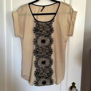 Cute tan shirt with black lace detail on front